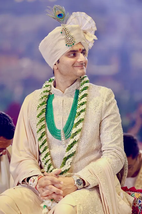 Groom with peacock-feather kalgi and green garland