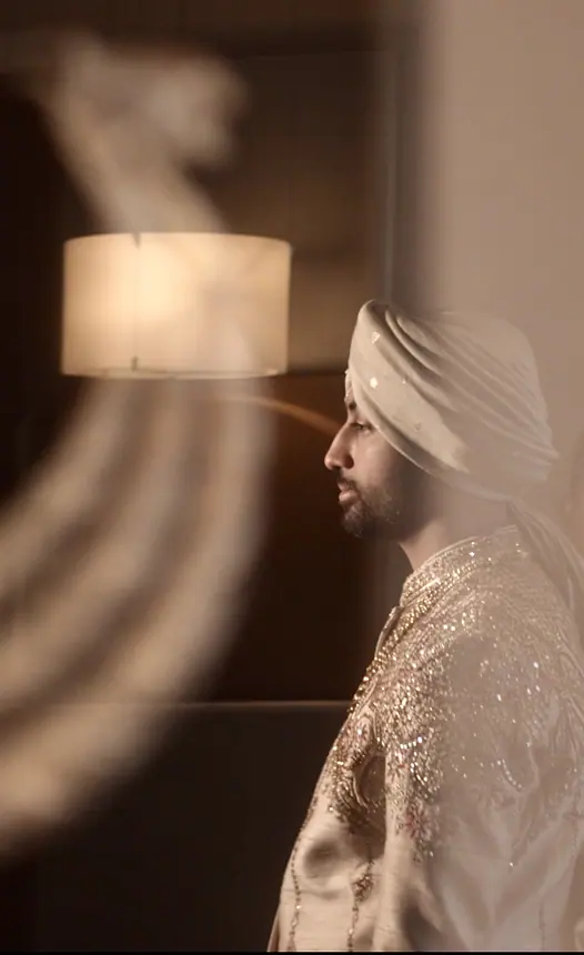 Groom in ivory safa, soft side profile