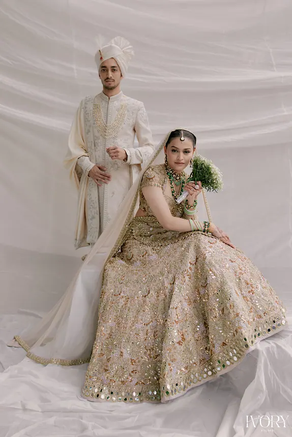Couple seated on a white backdrop