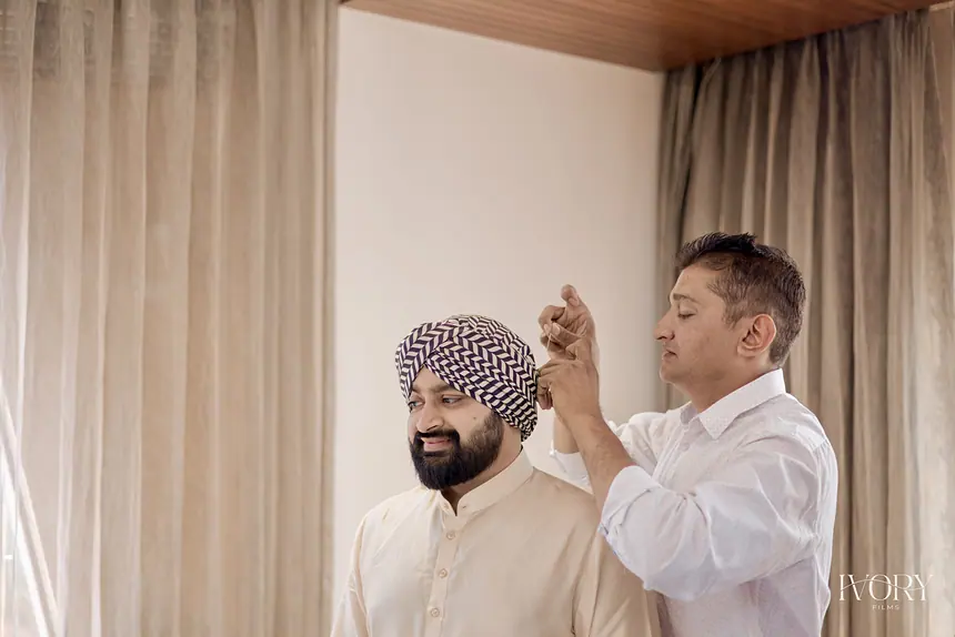 Kishore adjusting the groom's turban